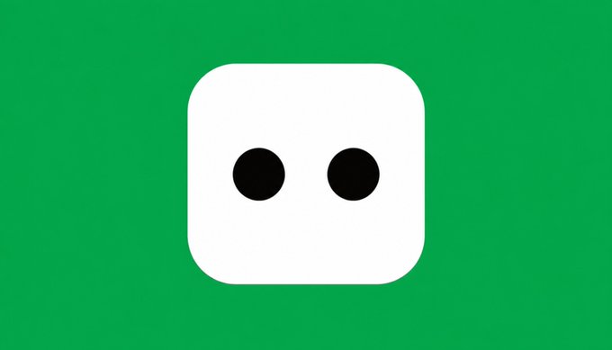 A simple white robot-like face with two black circular eyes on a solid green background, resembling an AI assistant logo.