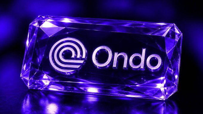 A purple-lit, crystal-like rectangular block displays the engraved logo and text "Ondo".