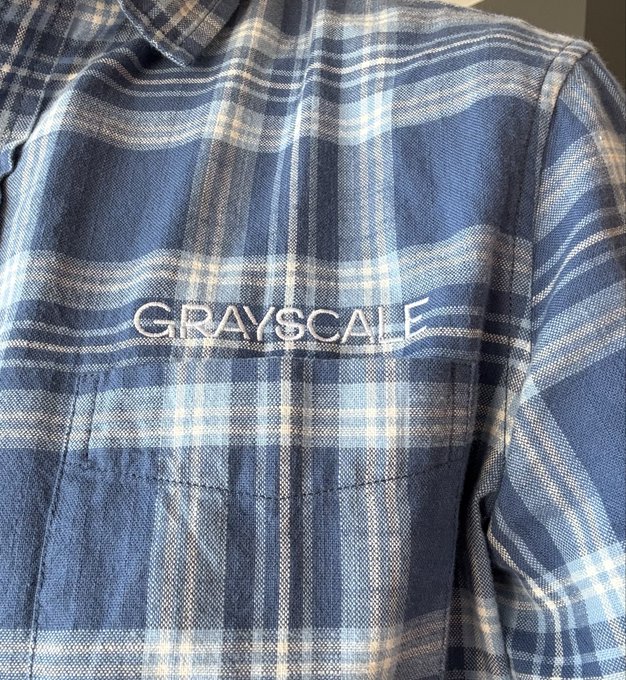 A blue plaid flannel shirt is shown with the word “GRAYSCALE” across the chest. The “$LINK” caption refers to the Grayscale Ethereum Trust, tying the shirt’s branding to the crypto post.