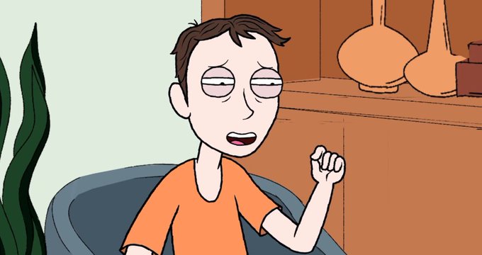 An animated cartoon character with a tired expression, wearing an orange shirt, sits on a blue couch and raises his fist.