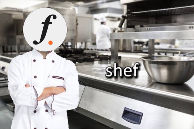 A chef in a white uniform with the falcon. logo replacing their head stands in a commercial kitchen with stainless steel equipment, labeled with the word 'shef'.