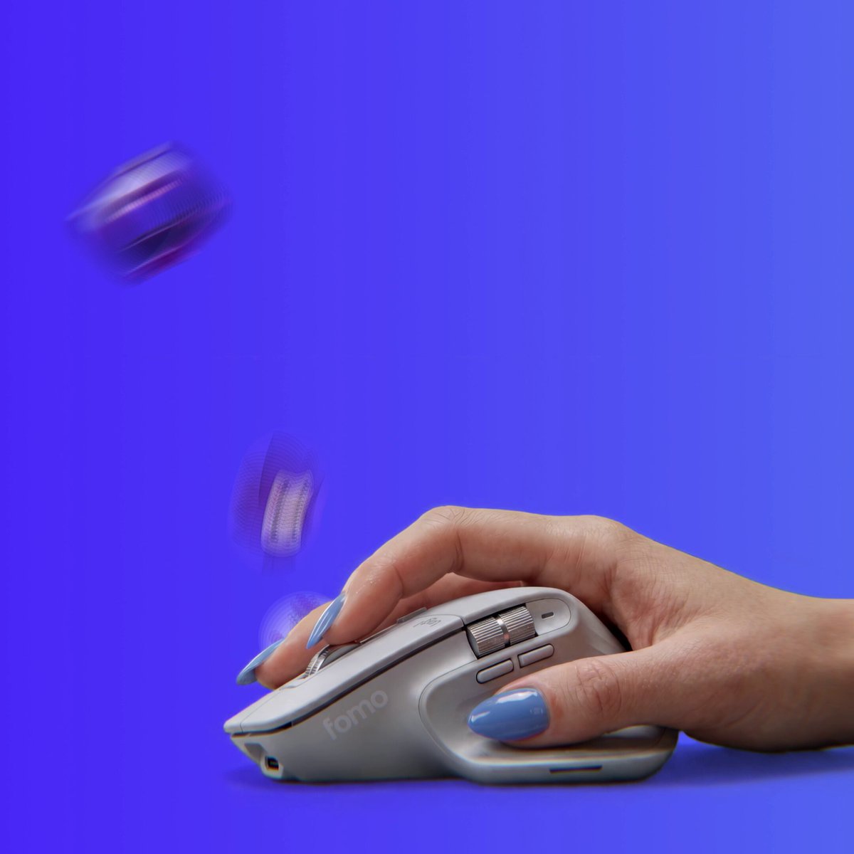 The image shows a person's hand holding a white computer mouse with blue nail polish, positioned over a blue background. The caption of the image reads "if you missed it: eth mainnet is officially live on fomo wen eth? we answered 5 chains live now". This suggests that the image was taken during an event or gathering related to cryptocurrency and blockchain technology, possibly at a meetup or convention.