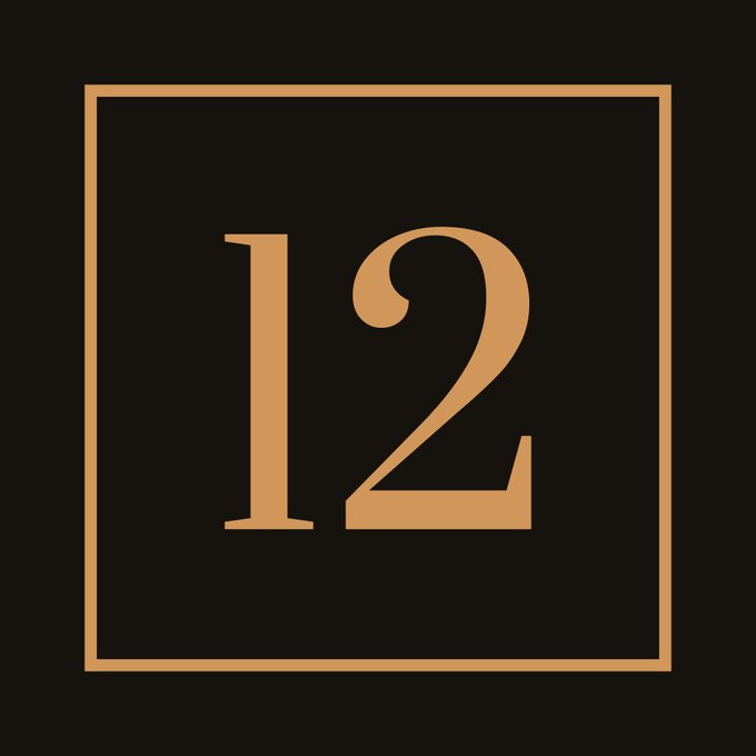 A minimalist graphic featuring a bronze-colored number '12' inside a matching square frame on a black background.