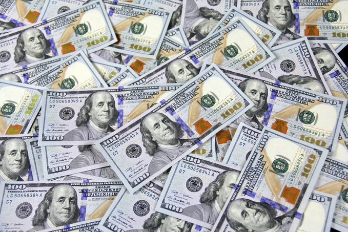 ???? US dollar bills of various denominations are scattered haphazardly, creating a sense of disarray and chaos.