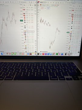 The image shows a computer monitor displaying various stock price data, which are being used for investment purposes or tracking financial trends. The screen of the monitor displays different price points indicating fluctuations over time. In addition to the main screen showing an upward trend, there is another smaller screen present in the lower right corner of the frame that may provide more detailed information about a specific stock or company's performance.