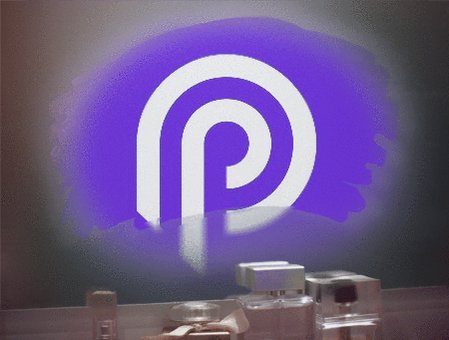 The image features a purple logo with white lettering that reads "P". The logo is displayed against a dark background, which makes it stand out prominently. In addition to the logo, there are several bottles of perfume arranged around the room, adding an element of luxury and sophistication to the scene.