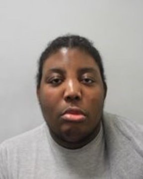 A mugshot-style portrait of a woman in a gray sweatshirt against a plain background, shared alongside a post warning about the dangers of publicly displaying cryptocurrency wealth after two crypto millionaires were reportedly kidnapped in east London.