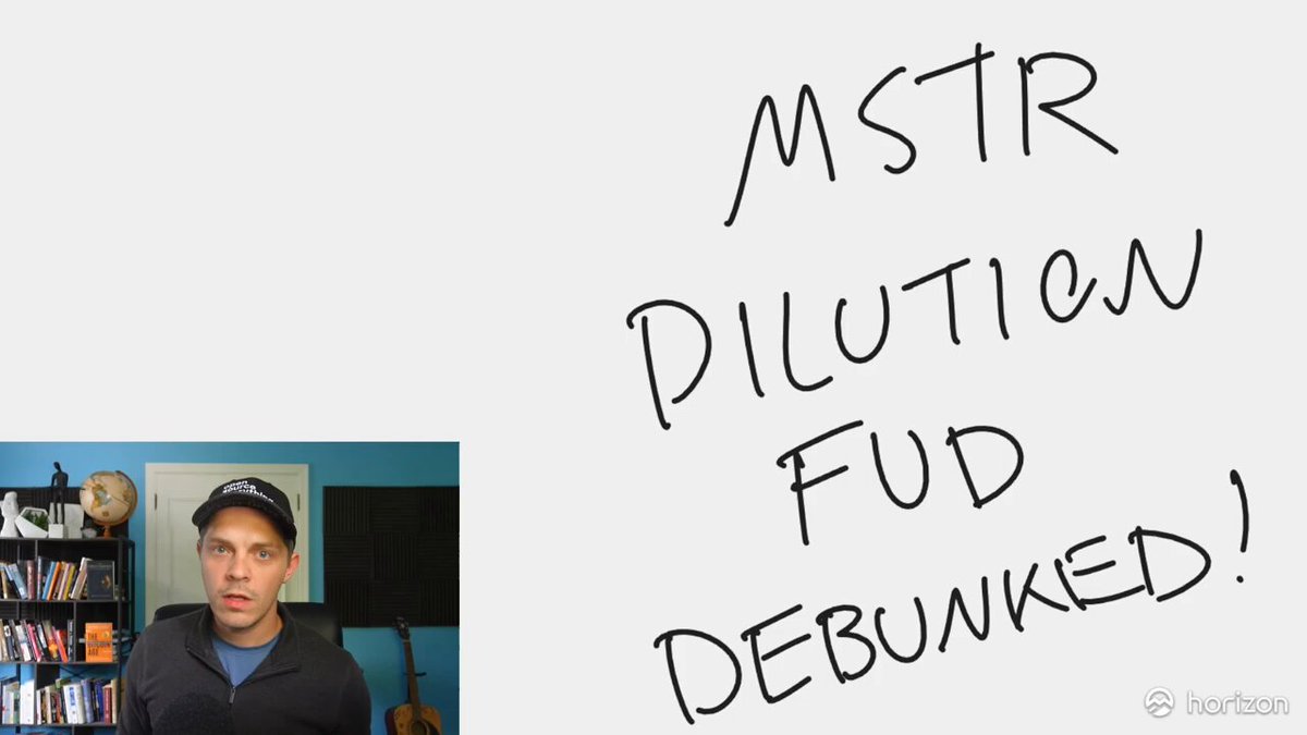 The image features a man sitting behind a whiteboard, with his face visible as he looks at the camera. The background of the image shows a bookshelf filled with various items such as books and a globe. The caption for the image reads "MSTR DILUTION FUD DEBUNKED! Tomorrow you are going to see a bunch of LOW IQ DOOMER SLOP from the idiots who exist to spread FAKE NEWS about Strategy".