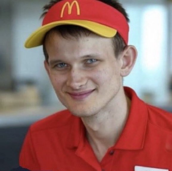 A young McDonald's employee in a red uniform and visor smiles at the camera, visually reinforcing the post's "WEN $5K SER" joke by personifying the typical fast-food worker persona often used to taunt investors impatient for Ethereum's price recovery after 11 years.