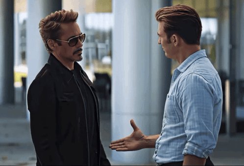 urney and roald, two characters from the Marvel Cinematic Universe, engage in a conversation on a city street.