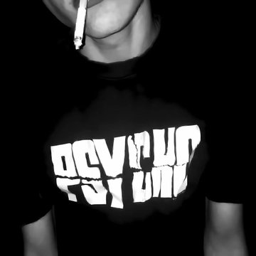 A black and white photo shows a person smoking a cigarette, wearing a black t-shirt with the text 'PSYCHO FOR YOU' printed in distorted white letters.