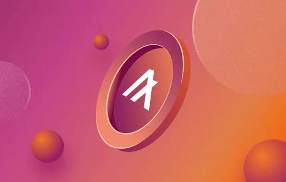 A 3D-rendered graphic displays a stylized 'A' logo inside a circular coin-like emblem against a pink and orange gradient background with floating spheres.