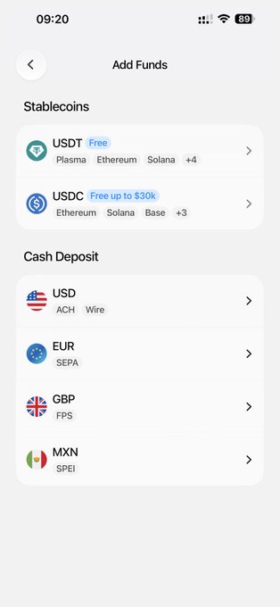 The image shows an app screen with a list of different currency options available for trading, including Bitcoin, Etherium, and others. The app displays the fees associated with each currency option, allowing users to compare them easily. The text on the screen indicates that the user can add funds to their account using these currencies or transfer money between them.