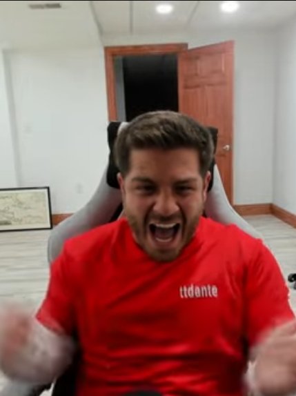 A man in a red t-shirt with 'ttdante' text shouting excitedly while seated in a gaming chair, appearing to be a streamer captured in an animated reaction.