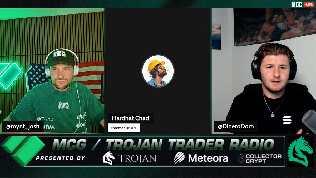 The image shows two men wearing headphones, possibly listening to a podcast or radio show. One man has his back towards the camera while the other man faces the camera. The main focus of the image seems to be their interaction with something on the screen in front of them. The background appears to be a green wall with some text visible, including "McG", "TROJAN TRADER radio" and "I just don't agree with the thesis that only L1 tokens can be SoV." This suggests an intellectual discussion or debate related to cryptocurrency and SoV (SpecialTokens). The men's positions relative to each other could imply a conversation about this topic, but it is unclear if they are discussing specific viewpoints on sov token regulations.