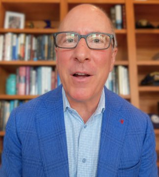 A man in a blue checkered blazer and glasses speaks in front of a bookshelf. The post identifies him as the President & CEO of the American Bankers Association, commenting on the Clarity Act and working with senators on small edits to help the bill pass.