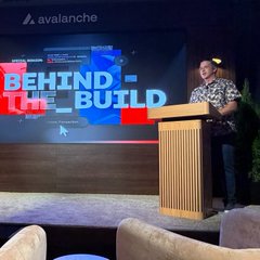 A man speaks at a podium during an Avalanche 'Behind the Build' event.