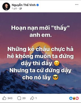 A Facebook post screenshot by Nguyễn Thế Vinh featuring Vietnamese text over a mountain sunrise: 'Hoạn nạn mới 'thấy' anh em. Những kẻ chầu chực hả hê không muốn ta đứng dậy thì đấy 😏 Những ta cứ đứng dậy cho nó lấy 😎'