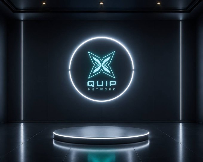 A futuristic dark room featuring a glowing circular neon sign on the back wall displays the "QUIP NETWORK" logo with a stylized cyan "X" emblem, while an empty illuminated podium sits centered on the glossy floor below. The staged, presentation-ready setting visually reinforces the post's theme of positioning Quip Network as a forward-thinking blockchain contender ready to lead the next computational race.