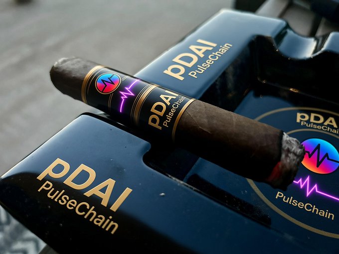 Product photo of PDAI PulseChain branded cigar resting on its matching branded box.