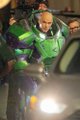 Buzz Lightyear, the iconic space ranger from Pixar's Toy Story, stands in a bright green and white spacesuit with arms outstretched, perfectly capturing the adventurous spirit of the post's "Peak of Tomorrow" caption.