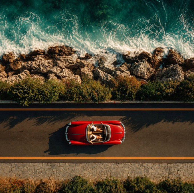 A vintage red convertible cruises along a scenic coastal road, the turquoise sea and rugged shoreline stretching beyond—evoking the smooth, scenic ride of a network like TRON powering the digital economy with speed and reliability.