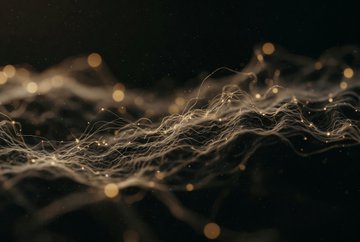 Abstract digital art featuring glowing golden particles and flowing white wispy threads against a dark background.