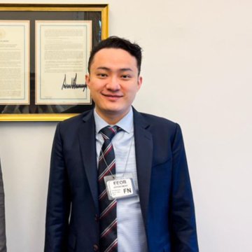 A man wearing a suit with a "WORLD LIBERTY FINANCIAL" name badge stands at what appears to be a crypto or financial event. The badge directly references the World Liberty Financial platform named in the headline about Justin Sun's $45 million lawsuit.