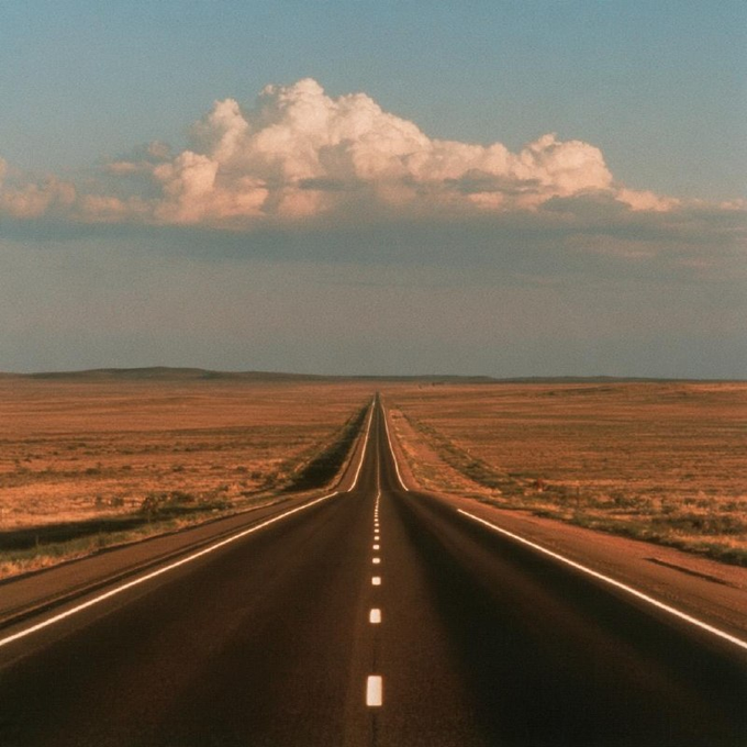 An empty two-lane highway stretches toward the horizon across a vast, arid landscape under a dramatic cloud formation, evoking the open, endless journey to Canton. The dusty plains and fading road mirror the repetition of the word "Canton" in the post, suggesting both distance and arrival.