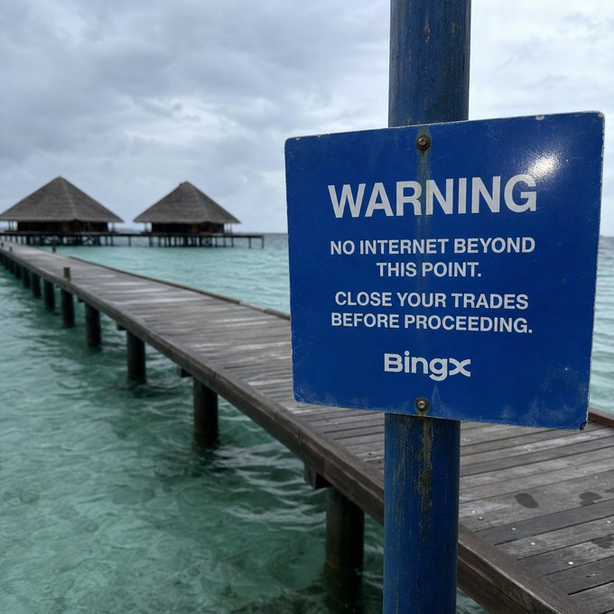 A blue warning sign on a wooden pier reads "WARNING NO INTERNET BEYOND THIS POINT. CLOSE YOUR TRADES BEFORE PROCEEDING." with the Bingx logo. The tropical overwater bungalow setting reinforces the post's message about giving your portfolio a break, suggesting that true disconnection—even from the crypto market—is necessary for true rest.