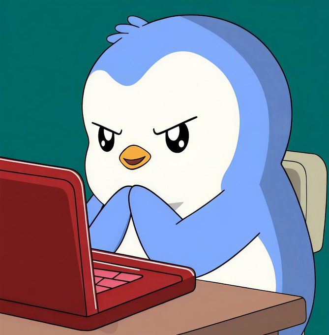A cartoon illustration of a blue and white penguin-like character with an angry expression sitting at a desk and typing on a red laptop.