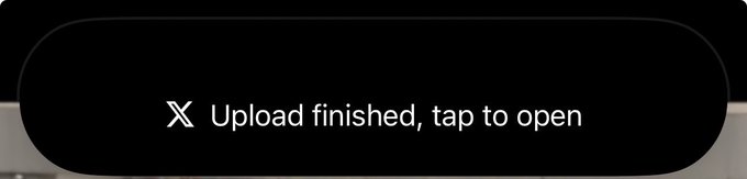 X (Twitter) upload confirmation notification reading 'Upload finished, tap to open.'