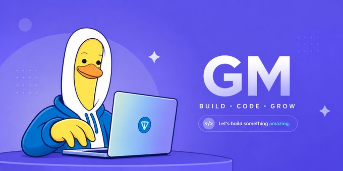 A cartoon duck wearing a white hoodie and blue jacket works on a laptop displaying the Viction logo, alongside the text "GM — BUILD • CODE • GROW" and a tagline "Let's build something amazing," visually tying into the "Gm fam" greeting by illustrating a crypto/Web3 "good morning" theme centered on building and coding.
