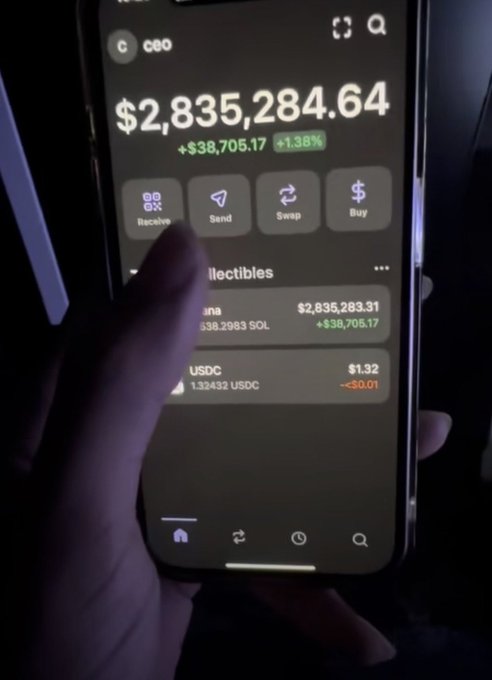 A hand holds a smartphone displaying a crypto wallet balance of '$2,835,284.64' (+$38,705.17, +1.38%) with holdings shown in SOL and USDC.