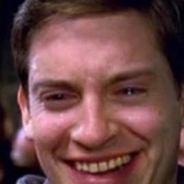 A close-up image of Tobey Maguire's character smiling awkwardly, a popular reaction meme often called the 'Spiderman awkward smile' face.