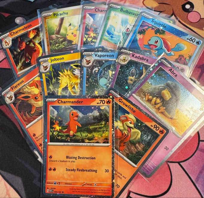 The image features a collection of Pokemon cards spread out on a surface, including various Pokemon characters such as Pikachu, Charmander, and others. The cards are arranged in different positions, showcasing their unique designs and colors. The post about the Pokemon cards reads "Happy Sunday Cosmos Holo Galore Continued...a few OGs", indicating that this is an ongoing series of posts featuring new Pokemon cards being released or shared by fans.

The image also contains text elements such as "Charmander" and "70". These words are likely part of a description or explanation about the cards, possibly related to their rarity, value, or other interesting details.