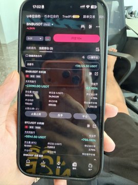 In this image, a person is holding up their cellphone displaying several numbers and text written in an Asian script that translates into "BNB unrealized profit of 20K USDT", which seems to be about Bitcoin. The cellphone also shows other text such as "$0.76R".
