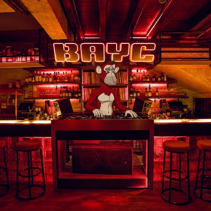 A DJ booth is lit by red neon lights beneath a glowing 'BAYC' sign, featuring a 2D animated ape character working the turntables.