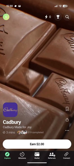 A mobile app interface, likely a rewards or survey platform, features a close-up photo of Cadbury chocolate bars and a task titled "Cadbury Made for Joy" offering $2.00.