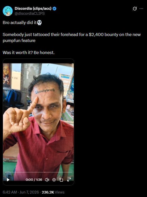 The image features a man with a tattoo of a skull on his forehead, which has been shared on social media platforms. The photo includes text that reads "Người thường farm airdrop bằng ví các xăm hình tên dự án là holder nữa.". The post is about the tattoo and its significance, possibly related to a marketing campaign or personal experience.