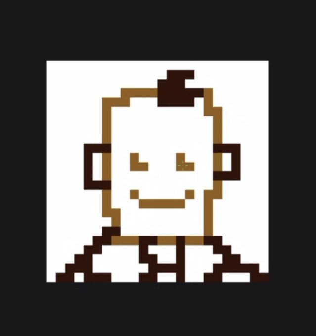 A simple pixel-art portrait of a smiling bald character with brown-tan coloring on a white background, rendered in a blocky retro style reminiscent of game sprites.