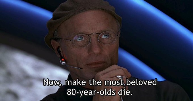 A scene from a film features a man wearing glasses, a beanie, and a headset, with a subtitle reading 'Now, make the most beloved 80-year-olds die.'