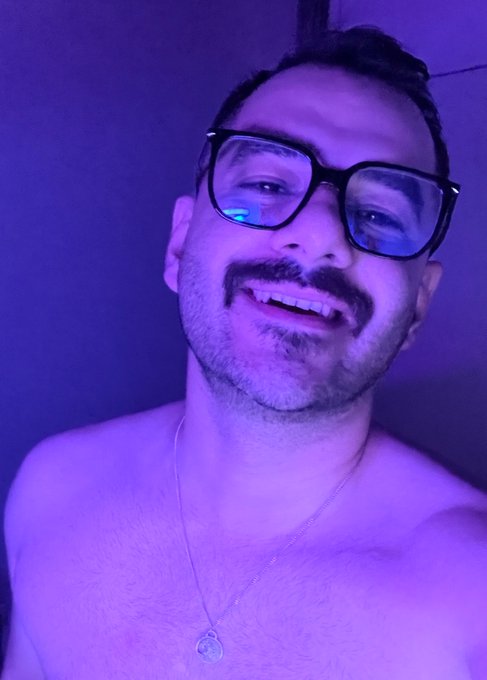A smiling shirtless man with glasses and a goatee poses for a selfie under purple lighting, wearing a pendant necklace. The casual, intimate photo complements the post's nighttime sign-off to the web3 community—capturing a personal "goodnight" moment.