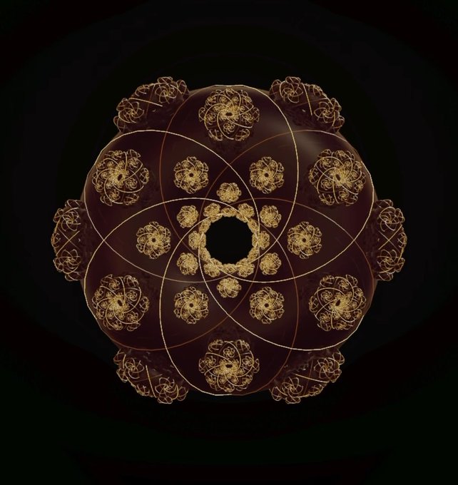 An intricate golden mandala-like fractal pattern with ornate, looping designs arranged in a circular symmetry against a black background.