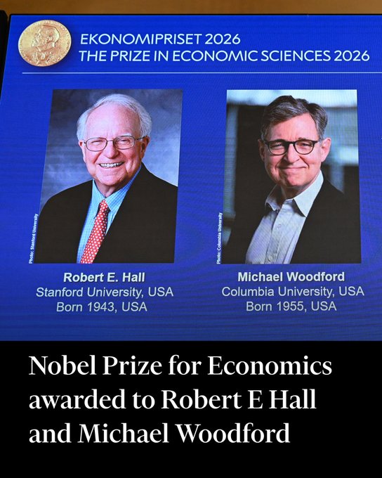 The display shows the announcement of the 2026 Nobel Prize in Economic Sciences awarded to Robert E. Hall (Stanford, born 1943) and Michael Woodford (Columbia, born 1955). The image ties to the caption's mocking critique of Keynesian economics, as both laureates are well-known for their work on macroeconomic dynamics and policy—hallmarks of the very school the post derides as a "stupid game" producing futile results ("deck chairs on the Titanic").