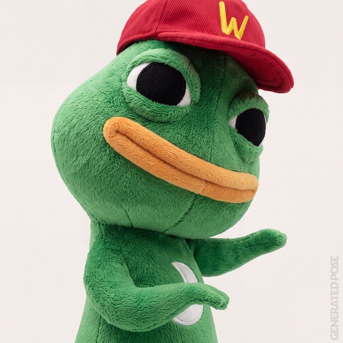 A green plush frog character wears a red baseball cap featuring a yellow "W" logo and points forward with a wide, toothy grin, paired with text on the right reading "GENERATED POSE." The mascot appears to be enthusiastically gesturing toward a "smol" acquisition, matching the post's playful call to acquire a "smolting."