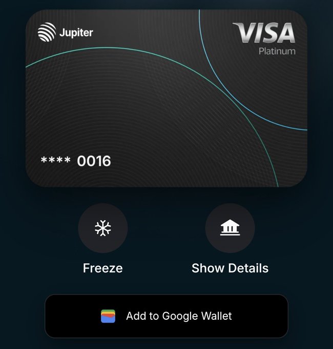 The image shows a screenshot of a Visa credit card page, with its design rendered in black and white color scheme. The background of the image has a dark blue hue, and there are several buttons scattered across the top left side of the screen. These buttons appear to be related to various functions or actions within the Credit Card system on the Visa website. 

The main focus of the image is an advertisement at the bottom that encourages viewers to "Add to Google Wallet". The text on this advertisement reads, "Klaim Kartu Kripto Grains dari @JupiterExchange Bornecuk Jalan Suraja. Link: jupiter.go.link/c6OQB Login pakai Google Masukkan Kode: JL9RF9X3 Selasaikan KYC Apply Kartu Jupiter Benefit: • Bonus $100 setelah spend $1000 dalam 30 hari sejak KYC - ... Cashback 4% - 10% ZeroFX Fee!". This advertisement emphasizes the user's ability to seamlessly transfer funds using their credit card and adds a bonus feature of cashback.