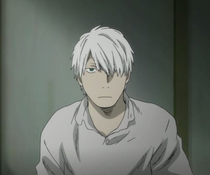 A screenshot from an anime showing a male character with white hair, a stern expression, and a white shirt sitting in a dimly lit room.