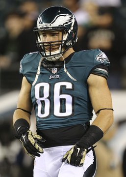 A Philadelphia Eagles football player wearing jersey number 86, a green uniform, and helmet, standing on the field.