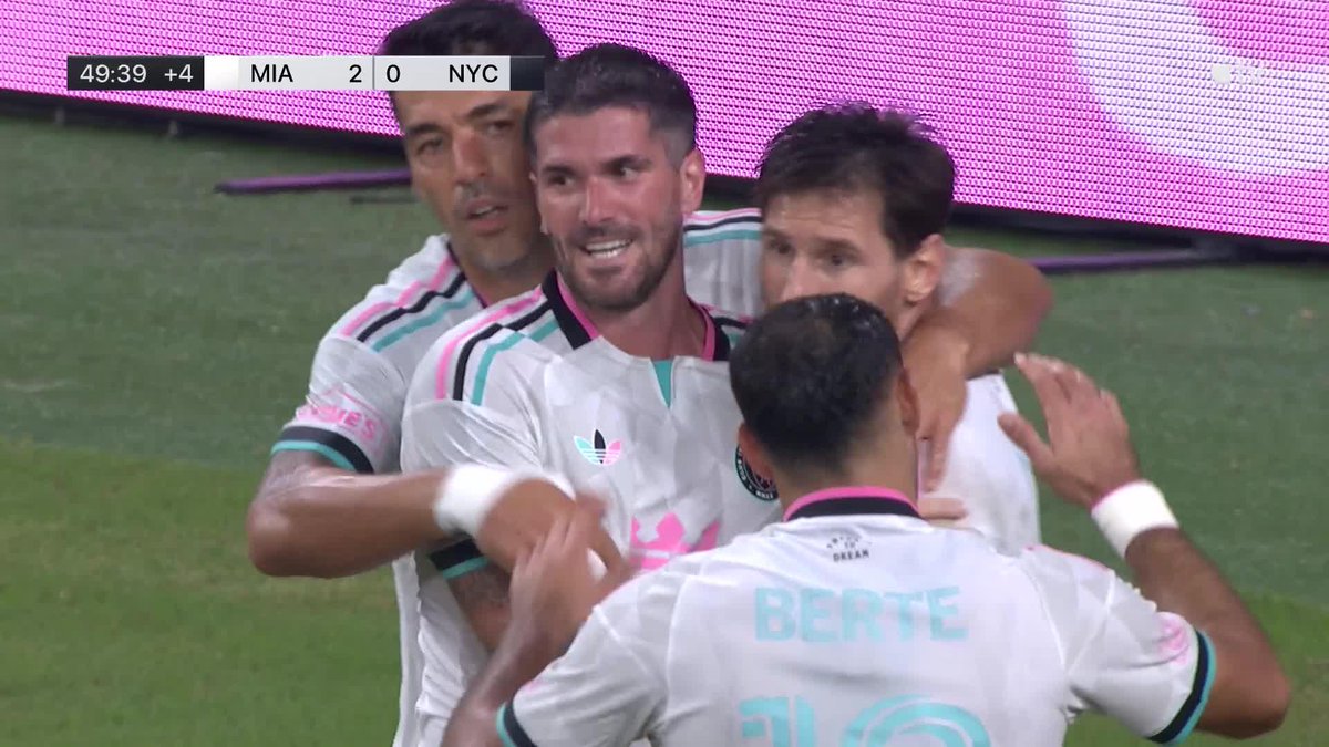 Soccer players in white and pink jerseys celebrating, with scoreboard '49:39 +4 MIA 2 0 NYC' and jersey name 'BERTE' visible.